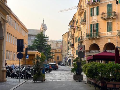 a city street with parked motorcycles and buildings at Antica in Savona