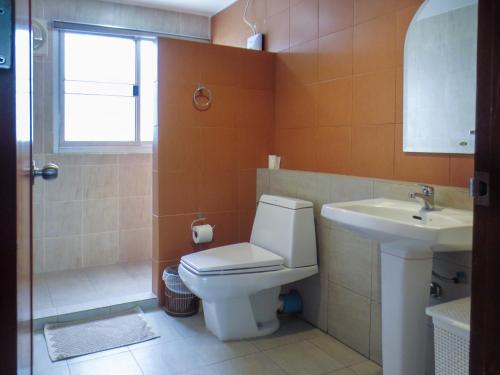 a bathroom with a toilet and a sink at P.K. Garden Home in Bangkok