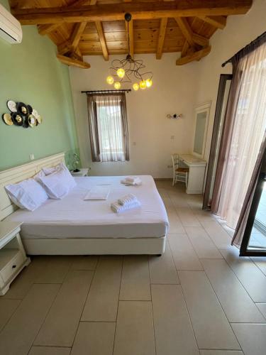a bedroom with a large white bed in a room at Kolokotronis Hotel & Spa in Stoupa