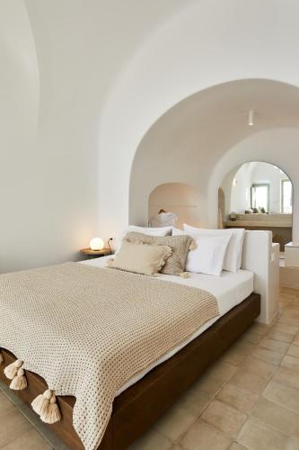 a bedroom with a large bed with a large mirror at Thiro Bliss Villa with private jacuzzi in Pyrgos