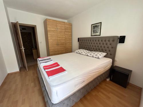 a bedroom with a large bed with a metal headboard at Nana's apartment in Varna City