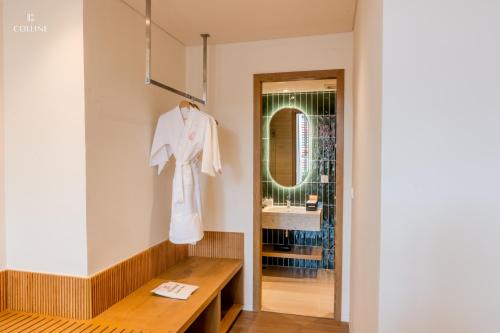 a dressing room with a white robe hanging on a wall at Colline Dalat in Da Lat
