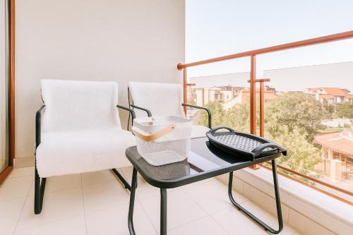 a room with a table and a chair and a window at Helios Seaview Apartment in Sveti Vlas