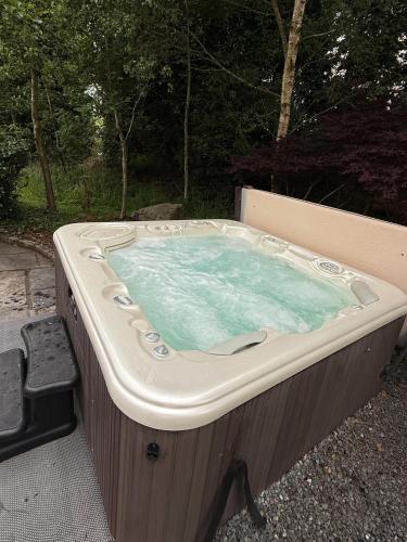 a jacuzzi tub sitting in a yard at Bluebell Cottage - with hottub in Newry