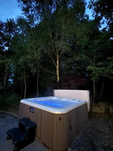 a hot tub in a yard with two chairs at Bluebell Cottage - with hottub in Newry