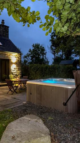 a swimming pool in the backyard of a house at Bluebell Cottage - with hottub in Newry