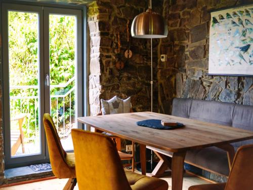 a dining room with a wooden table and chairs at Ferienhaus NaturReich in Bad Berleburg
