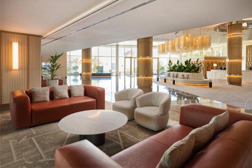 a lobby with couches and chairs and a table at Hipotels Playa de Palma Palace&Spa in Playa de Palma