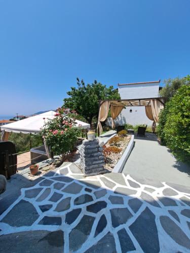 a patio with a stone walkway with a fire place at Iordanis house- Traditional House in old Alonnisos in Alonnisos Old Town