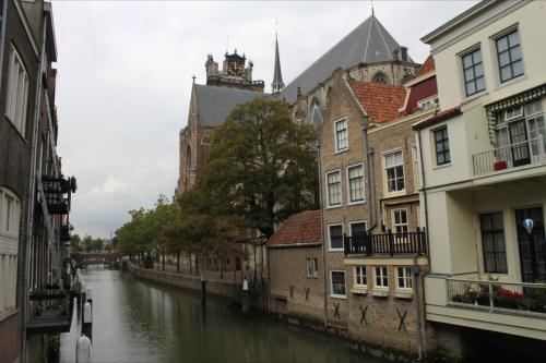 a river in a city with buildings next to a canal at Blom aan de Gracht in Dordrecht