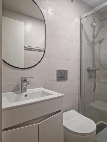 a bathroom with a sink and a toilet and a mirror at House Lisboa in Lisbon