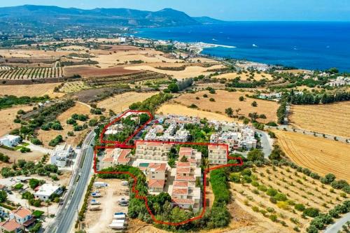 an aerial view of an apartment complex next to the ocean at Happy Village - Latchi in Polis Chrysochous