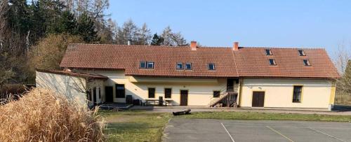 a large white house with a brown roof at Chalupa Na Studené Vodě 