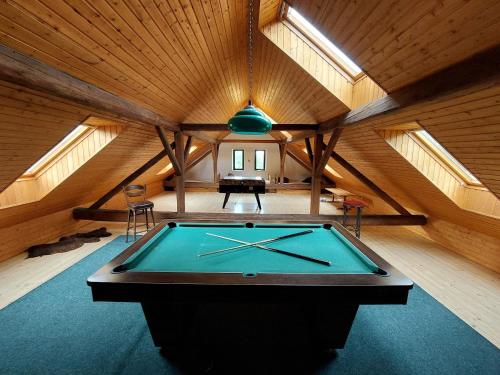 a pool table in the middle of a room at Chalupa Na Studené Vodě 