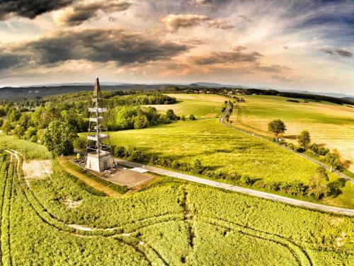 an aerial view of a field with a windmill at Vila Hamrska in Velké Hamry