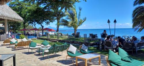 a group of people sitting in chairs by the ocean at Matavai View - Premium Oceanfront Suite in Arue