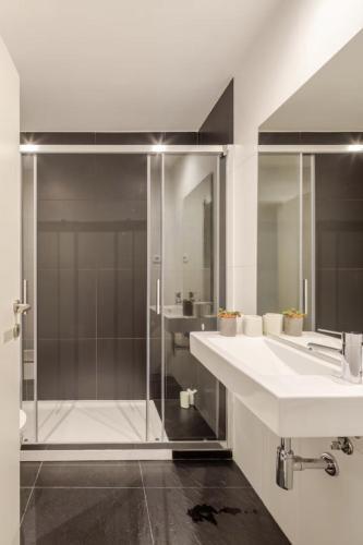 a bathroom with a glass shower and a sink at Algae n'areia in Moledo