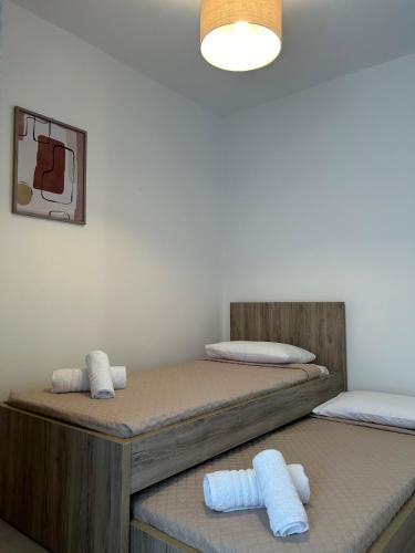 two beds in a room with towels on them at Serenity in Kefalos