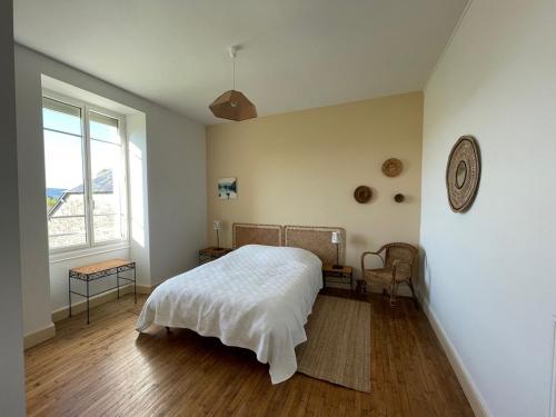 a bedroom with a bed and a large window at Charming country house 