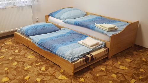 two bunk beds in a room with yellow leaves on the floor at Penzion Mika in Jindřichŭv Hradec