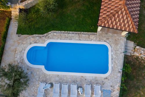 an overhead view of a swimming pool next to a house at Villa Magic with heated pool in Trbounje
