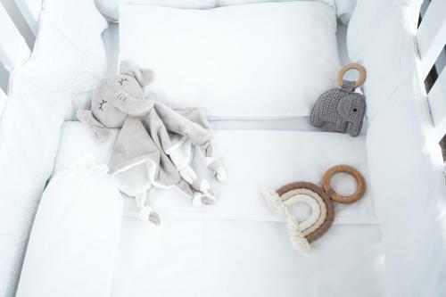 a white crib with a toy elephant and a ring at Rosewood Bangkok in Bangkok