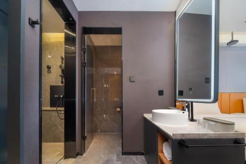 a bathroom with a sink and a shower at Atour X Hotel Xuefu Street Taiyuan South Railway Station in Taiyuan