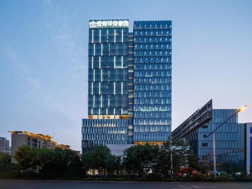 a tall building with many windows in a city at Atour X Hotel Xuefu Street Taiyuan South Railway Station in Taiyuan