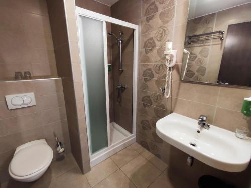 a bathroom with a toilet and a sink and a shower at Villa Sunce in Punat