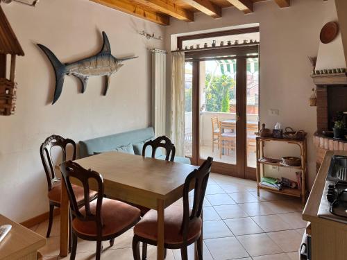 a kitchen and dining room with a table and chairs at Airy & panoramic with terrace, 2 minutes from the sea in Venice-Lido