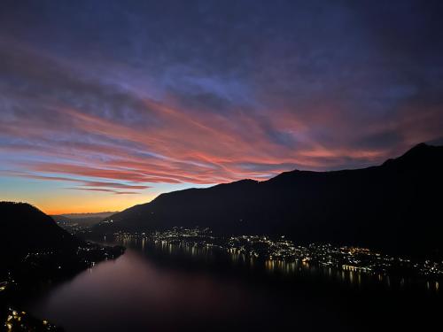 a view of a body of water at sunset at Mamo's Belvedere by Holiday Solutions in Faggeto Lario 