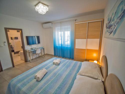 a bedroom with two towels on a bed at Villa Sunce in Punat