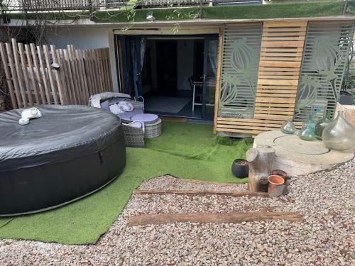 a backyard with a large tire on the grass at Au bon vivre l'appartement in Saint-Guiraud
