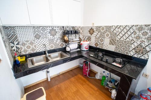 a kitchen with a sink and a counter top at Villa Griya Timoho Private Pool in Demangan