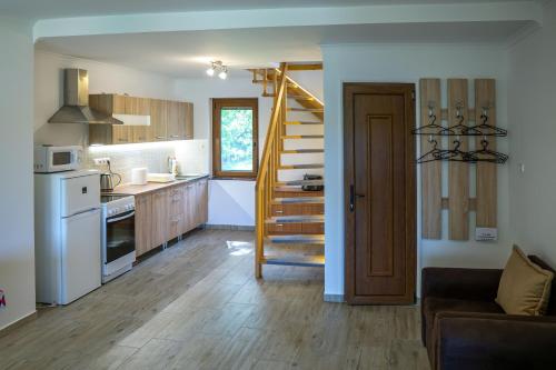 a kitchen with a staircase and a living room at Megafish Camp in Dunafalva
