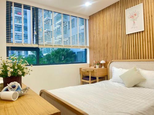 a bedroom with a bed and a table and a window at Châu Giang Homestay, Nera Garden Huế in Thôn Văn Dương