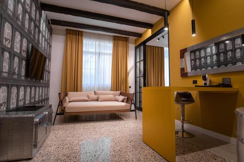 a living room with a couch and a yellow wall at Palazzo Sebeto in Naples