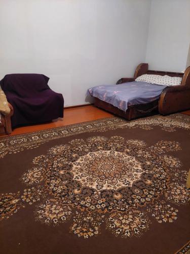 a room with a rug on the floor and a bed at Ojakh in Dilijan