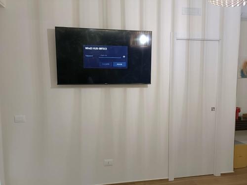 a flat screen tv hanging on a white wall at PIANESE house 1 in Campobasso
