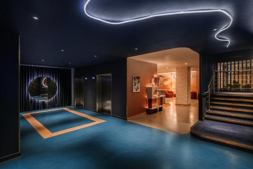 a room with a blue floor and a stair case at Mercure London Earls Court in London