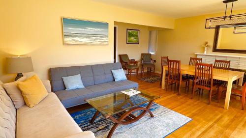 a living room with a couch and a table at Spacious home 15mins to Downtown in Vancouver