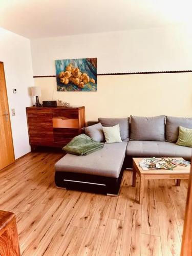 a living room with a couch and a table at Haus HarzZauber - Elegantes Ferienquartier in der Altstadt mit Terrasse, Kamin und E-Bikes für die perfekte Auszeit in Wernigerode