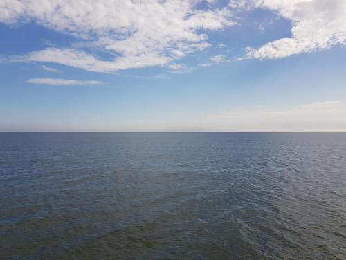 an image of the ocean with a cloudy sky at Strandhotel Prinz von Preussen in Zinnowitz
