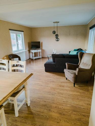 a living room with a couch and a table at Lakefront house on Skåne's largest island in Ivö