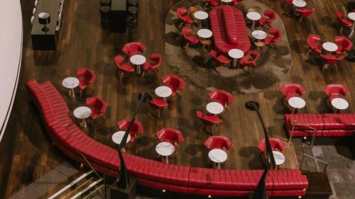 an overhead view of a dining room with red tables and chairs at InterContinental Brisbane by IHG in Brisbane