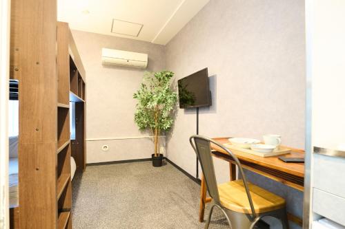 a dining room with a table and a tv at Sapporo - Apartment - Vacation STAY 29196v in Sapporo