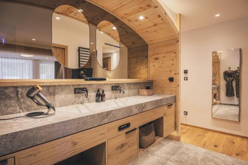 a bathroom with a large sink and a mirror at Hotel Klosterbräu in Seefeld in Tirol