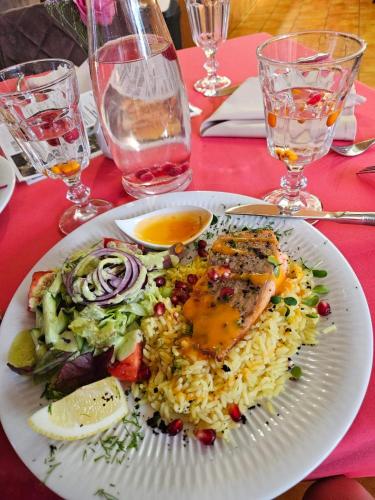 a plate of food with rice and vegetables on a table at Hotel resort Sedula in Skogalis