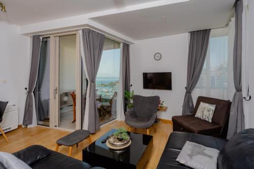 a living room with a couch and chairs at City Apartments 2 in Budva