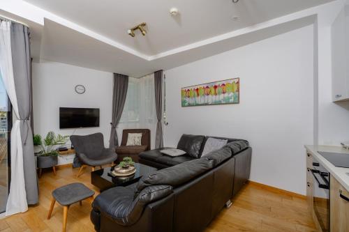 a living room with a couch and a table at City Apartments 2 in Budva